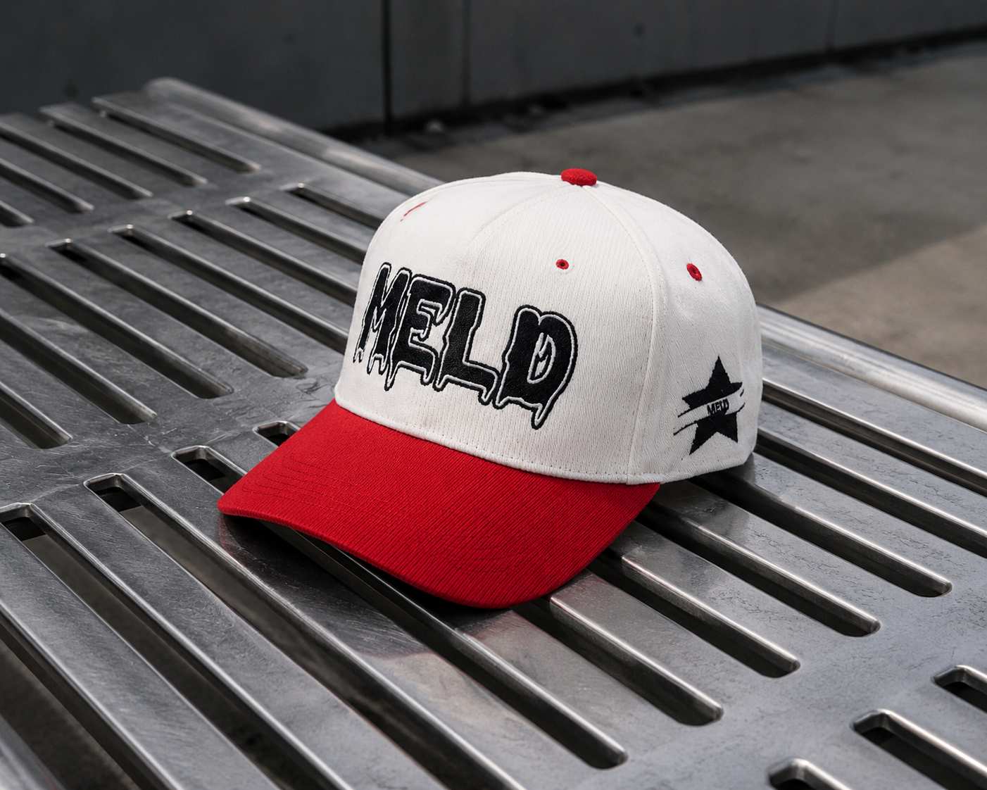 MELD WORLD corduroy cap on a metal grate street backdrop